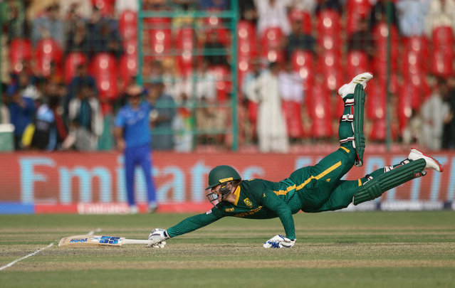 South Africa's Ryan Rickleton dives to avoid a run out during the match against Afghanistan in Karachi, Pakistan, on February 21, 2025. (Photo by Zoral Naik/Reuters)