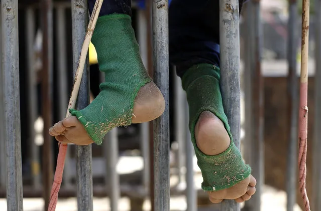Feet of an Indonesian child jockey are seen as he sits on a starting gate shortly before a traditional horse race marking Indonesia's 70th independence anniversary, in Bima, West Nusa Tenggara province, Indonesia, 09 August 2015. (Photo by Mast Irham/EPA)