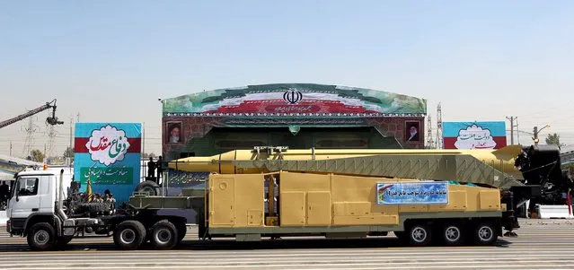 A military truck carrying a Qadr H missile drives past pictures of Iran's Supreme Leader Ayatollah Ali Khamenei (R) and late leader Ayatollah Ruhollah Khomeini during a parade marking the anniversary of the Iran-Iraq war (1980-88), in Tehran September 22, 2015.. (Photo by Raheb Homavandi/Reuters/TIMA)