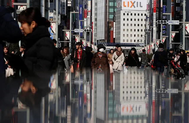 People walk on a street at Tokyo's Ginza shopping district February 15, 2015. (Photo by Yuya Shino/Reuters)