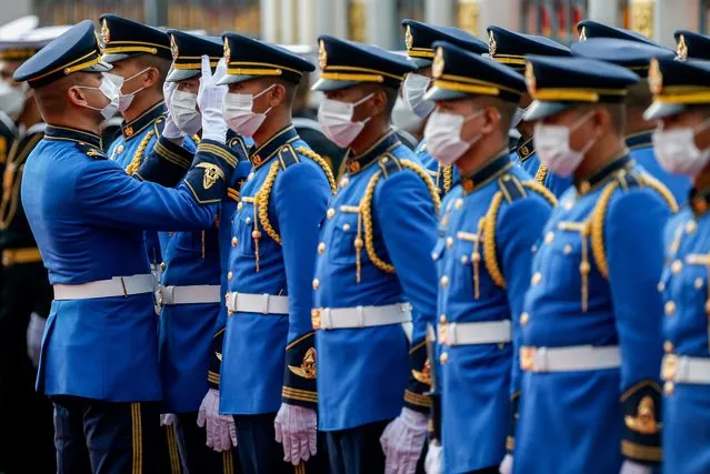 Members of the guard of honour organize the hat of their colleague before a welcoming ceremony for Vietnam's President Nguyen Xuan Phuc at the Government House in Bangkok on November 16, 2022. (Photo by Chaiwat Subprasom/SOPA Images/Rex Features/Shutterstock)
