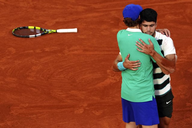 Spain's Carlos Alcaraz hugs Italy's Jannik Sinner after winning the final match of the French Tennis Open at the Roland-Garros in Paris, Sunday, June 8, 2025. (Photo by Aurelien Morissard/AP Photo)