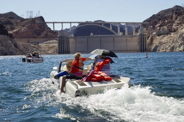 A 1965 Amphicar driven by Dean Baker of Lake Havasu, Arizona heads toward Hoover Dam during the first Las Vegas Amphicar Swim-in at Lake Mead near Las Vegas, Nevada October 9, 2015. (Photo by Steve Marcus/Reuters)