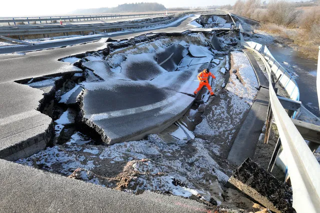 Surveyors of the State Office for Traffic and Transport scan the sagged Baltic Sea freeway near Tribsees, Germany, 07 February 2018. The sag is getting bigger and bigger. The originally 40-metre-big hole now is 95-metre big, according to the Ministry of Transport upon request. (Photo by Bernd Wüstneck/DPA/Picture-Alliance/Barcroft Images)