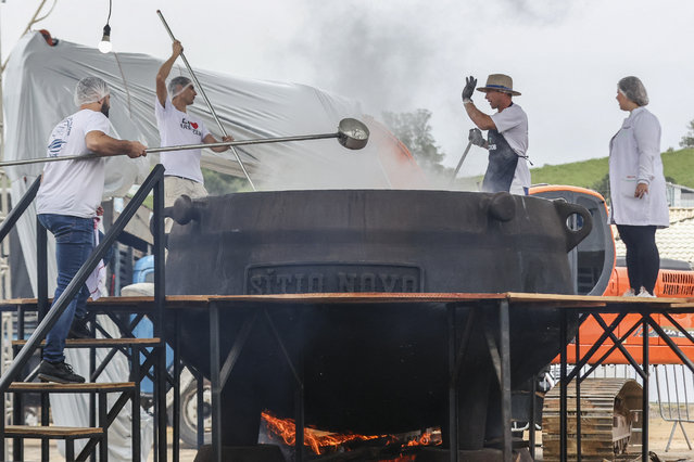 Chefs prepare a broth with over 700kg of tilapia, a freshwater fish, during the Tilapia Regional Festival in Armazem, Brazil on April 28, 2024. Armazem has a population of just over 9,000 people and is the region's leading producer of tilapia in ponds. (Photo by Anderson Coelho/AFP Photo)