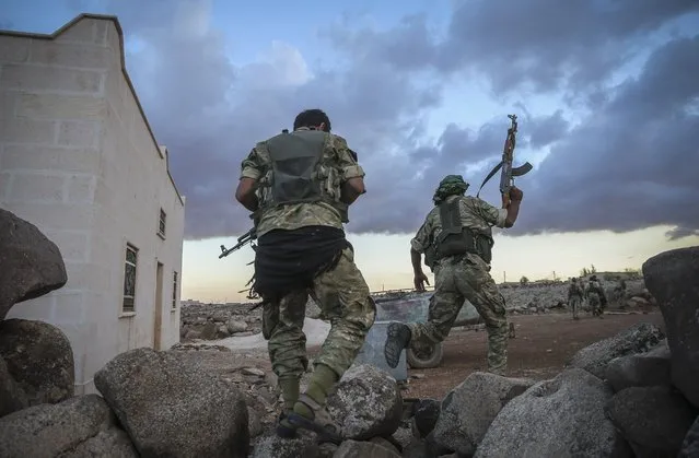 Free Syrian Army members are seen in a village of Cobanbey town in Jarabulus as they carry out an operation within the “Operation Euphrates Shield”, led by the Turkish Army and backed by Syrian National Coalition forces including the Free Syrian Army in Aleppo, Syria, September 23, 2016. (Photo by Emin Sansar/Anadolu Agency/Getty Images)