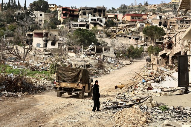 A returning resident walks near a damaged site amid destroyed buildings, as Israeli troops withdrew from most of south Lebanon, in the southern Lebanese village of Kfar Kila, Lebanon, on February 19, 2025. (Photo by Emilie Madi/Reuters)
