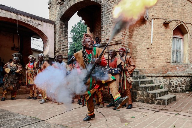 A Bamoun warrior responsible of the security of the Sultan King of the Bamouns shoots into the air during the start of the inauguration ceremony of the new Bamoun Kings Museum in Foumban, on April 13, 2024. Cameroon is home to 270 ethnic groups with different customs and languages, and officially, more than 80 first-degree chiefdoms dating from the precolonial era. The kingdom of the Bamouns, founded in 1384, is today one of the oldest in sub-Saharan Africa. The new Bamoun Kings Museum, inaugurated on April 13, 2024, was built reproducing the coat of arms of the kingdom over 5,000 square meters and three floors, and houses nearly 12,500 items reflecting the richness, variety, and craftsmanship of the Bamoun artisans. (Photo by Daniel Beloumou Olomo/AFP Photo)