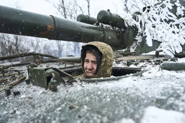 A Ukrainian soldier looks out of a self-propelled artillery vehicle on the frontline, Donetsk region, Ukraine, Saturday, February 18, 2023. (Photo by Libkos/AP Photo)