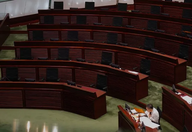 Empty seats of pro-democracy legislators are seen at Legislative Chamber in Hong Kong, Thursday, November 12, 2020. Hong Kong's legislature opened Thursday ahead of the planned mass resignation of its pro-democracy bloc, one day after the government ousted four of its members. (Photo by Vincent Yu/AP Photo)
