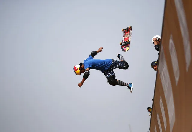 A skateboarder falls as he competes at the Vert Ramp competition during the World Extreme Games in Shanghai April 30, 2014. (Photo by Carlos Barria/Reuters)