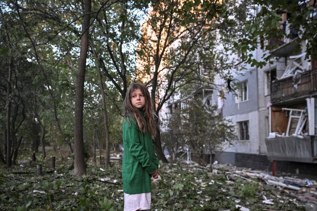 A girl stands near her apartment building damaged by a missile strike amid Russia’s massive attack on Ukraine in Zaporizhzhia on September 28, 2025. (Photo by Reuters/Stringer)
