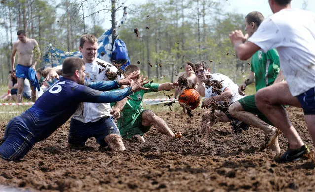 Soccer enthusiasts compete in the Swamp Football Cup of Russia in the village of Pogi in Leningrad Region, Russia June 16, 2018. (Photo by Anton Vaganov/Reuters)