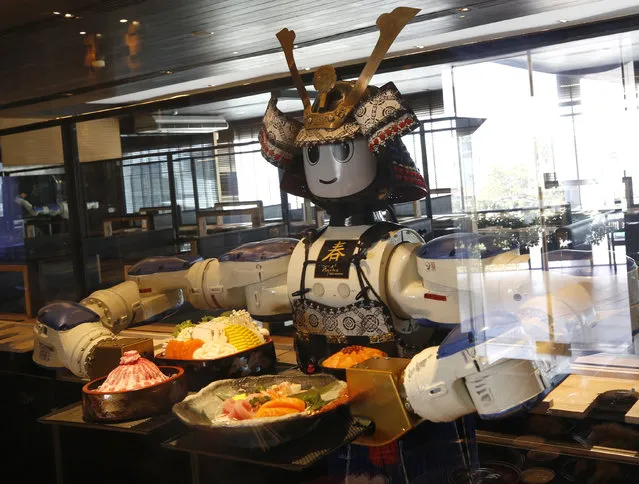 A robot serves customers at a Japanese robot restaurant amid a new wave of coronavirus disease (COVID-19) in Bangkok, Thailand, 15 January 2021. Thailand's first Japanese robot restaurant Hajime, where the serving waiters are robots, has been operating since 2010, serving Japanese food shabu, yakiniku and sushi. After one year since the first COVID-19 infection in the country, Hajime has more than two times more customers than before. (Photo by Narong Sangnak/EPA/EFE)