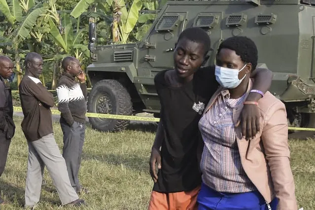 A boy is conforted at the scene of an attack in Mpondwe, Uganda, on June 17, 2023 at the Mpondwe Lhubiriha Secondary School. The death toll from an attack on a school in western Uganda by militants linked to the Islamic State group has risen to 37, the country's army spokesman said Saturday. (Photo by AFP Photo/Stringer)
