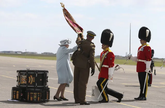 Britain's Queen Elizabeth II, Colonel-in-Chief Royal Scots Dragoon Guards (Carabiniers and Greys), left, during a ceremony to present a new standard to the regiment, at Leuchars Station in Fife, Scotland, Thursday July 5, 2018. (Photo by Andrew Milligan/PA Wire via AP Photo)