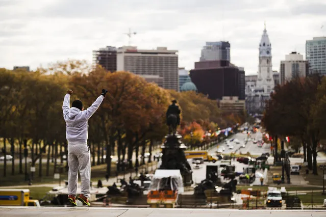 Alex Carrillo Quito of Ecuador imitates the character Rocky Balboa from the 1976 movie “Rocky”, on the steps of the Philadelphia Museum of Art, in Philadelphia, Monday, November 21, 2016. Four decades after the Nov. 21, 1976, premiere of “Rocky”, the movie's reach is international, and the title character's underdog tale of determination, grit and sleepy-eyed charm still resonates with fans. (Photo by Matt Rourke/AP Photo)