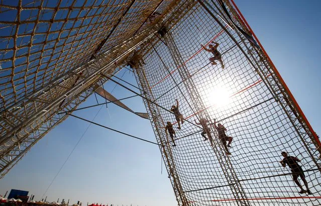 Competitors participate in Egypt's Tough Mudder challenge organized by “TriFactory”, an Egyptian sports management company, amid the coronavirus disease (COVID-19) pandemic, at the O West district in Giza, Egypt on March 7, 2021. (Photo by Amr Abdallah Dalsh/Reuters)