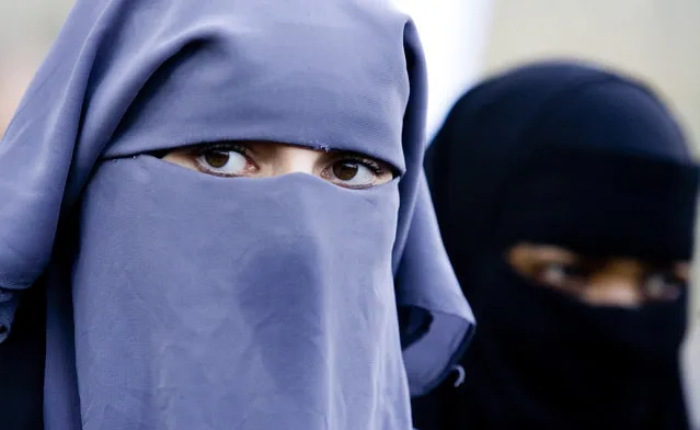 In this November 30, 2006 file photo unidentified women are seen wearing a niqab in The Hague, Netherlands. The Dutch Parliament’s lower house voted on Tuesday to ban the wearing of face-covering clothes – such as burqas and niqabs – in some public places, making the Netherlands the latest European country to restrict garments worn by some Muslim women. (Photo by Fred Ernst/AP Photo)