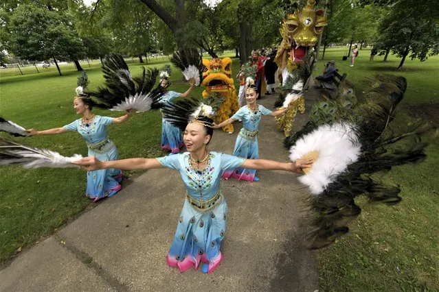 Members of the Tai Ji Men Qigong Academy practice before the Parliament of World Religion Parade of Faiths, Sunday, August 13, 2023, in Chicago. (Photo by Paul Beaty/AP Photo)