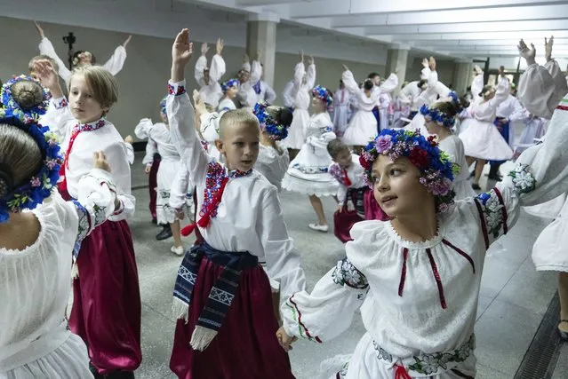 Schoolchildren dance as they attend a ceremony, on the first day in school in Kharkiv, Ukraine, Friday, September 1, 2023. Ukraine marks Sept. 1 as Knowledge Day, as a traditional launch of the academic year. (Photo by Mstyslav Chernov/AP Photo)
