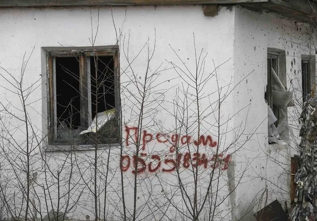A building damaged by fighting is pictured near Debaltseve, eastern Ukraine, February 20, 2015. Fighting persisted in east Ukraine on Friday despite new European efforts to ensure a ceasefire takes hold. An inscription on the house reads:"For sale".  REUTERS/Gleb Garanich  (UKRAINE - Tags: POLITICS CIVIL UNREST MILITARY CONFLICT)