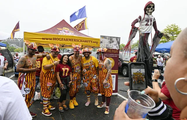 Washington Commanders fans called the Hog Farmers pose with other fans during a tailgate party prior to action against the Arizona Cardinals at FedEx field on September 10, 2023. (Photo by Jonathan Newton/The Washington Post)