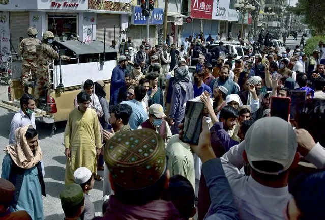 Army soldiers arrive to control the situation at a market, where traders gathered protesting against the lockdown announced to help control the spread of the coronavirus, in Quetta, Pakistan, Monday, May 10, 2021. (Photo by Arshad Butt/AP Photo)