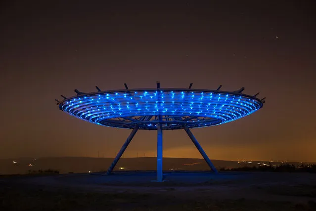 The sun sets behind the Haslingden Halo Panopticon on January 20, 2016 in Haslingden, England. The Halo installation designed by John Kennedy of LandLab sits on a hill called Top o' Slate, a reclaimed landfill site in East Lancashire and has become a major landmark since opening in 2007. “Halo” is the centrepiece of panopticons art projects, led by the REMADE in Lancashire programme, Groundwork and Rossendale Council, which has reclaimed and returned to public use 33 hectares of land. (Photo by Christopher Furlong/Getty Images)