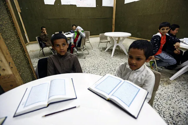 Saudi brothers of al-Fefi family attend a Koran class after making their way to their school through Fifa Mountain, in Jazan, south of Saudi Arabia, December 15, 2016. (Photo by Mohamed Al Hwaity/Reuters)