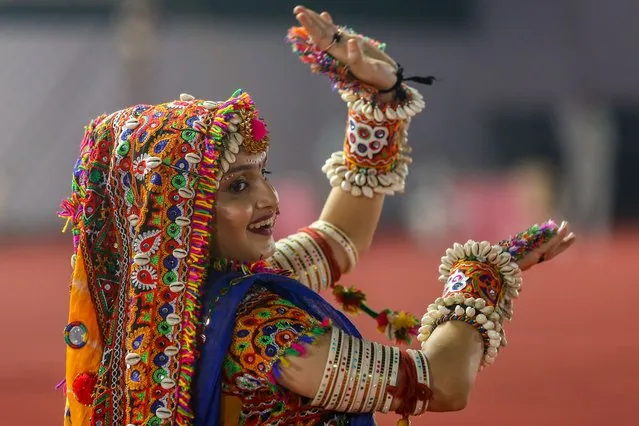 A young woman wearing traditional attire participates in a Garba dance performance during Navaratri festival celebrations in Mumbai, India, 16 October 2023. The word Navaratri literally means “nine nights” in Sanskrit. During Navaratri, nine forms of Durga (Hindu Mother Goddess) are worshiped. Navaratri is a festival of worship, dance and music celebrated over a period of nine nights, the tenth day is commonly referred as Vijayadashami or Dussehra. (Photo by Divyakant Solanki/EPA)