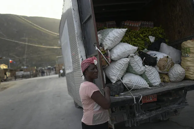 An Haitian vendor stands by a truck filled with vegetables at the closed border with Haiti in Jimani, Dominican Republic, Thursday, July 8, 2021. (Photo by Matias Delacroix/AP Photo)