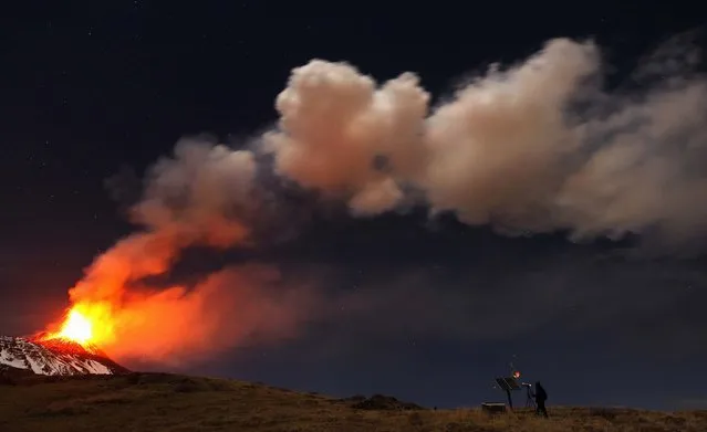 A photographer takes pictures of Mount Etna spewing lava as it erupts on November 17, 2013. (Photo by Antonio Parrinello/Reuters)