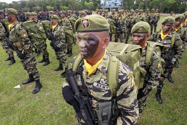 Troops stand at attention during the celebration of the 118th Founding Anniversary of the Philippine Army at the military headquarters in Fort Bonifacio, Taguig City, Metro Manila March 23, 2015. (Photo by Romeo Ranoco/Reuters)