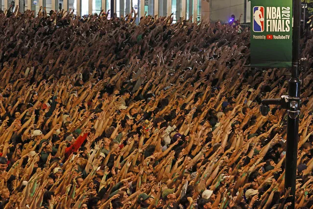 Fans watch Game 6 of the NBA basketball finals game between the Milwaukee Bucks and Phoenix Suns Tuesday, July 20, 2021, in Milwaukee. (Photo by Jeffrey Phelps/AP Photo)