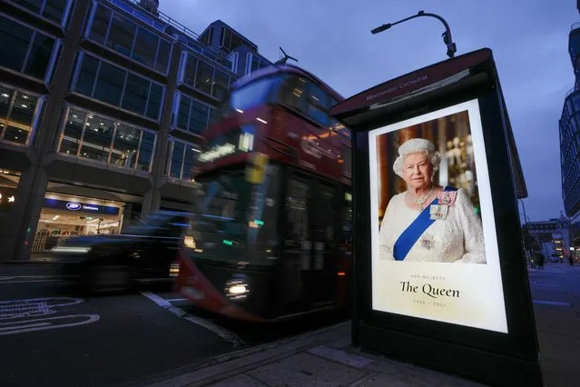 A picture of Queen Elizabeth sits on a bus stop in London, Friday, September 9, 2022. Queen Elizabeth II, Britain's longest-reigning monarch and a rock of stability across much of a turbulent century, died Thursday Sept. 8, 2022, after 70 years on the throne. She was 96. (Photo by /Kirsty Wigglesworth/AP Phot)
