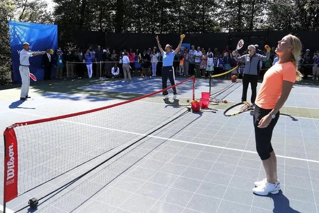 U.S. President Barack Obama (L) reacts to hitting a winner down the line against a tough volley from tennis player Caroline Wozniacki (R), one of the activities at the annual Easter Egg Roll at the White House in Washington April 6, 2015. (Photo by Jonathan Ernst/Reuters)