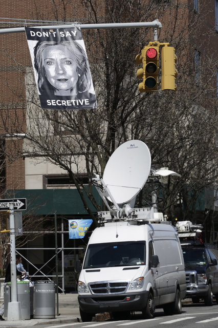 An unknown artist placed a poster on a traffic signal in front of the building where Hillary Rodham Clinton's presidential campaign offices are located, Sunday, April 12, 2015 in the Brooklyn borough of New York. A top adviser to Clinton announced her much-awaited second campaign for the White House on Sunday in an email to alumni of her first presidential campaign. (Photo by Mark Lennihan/AP Photo)