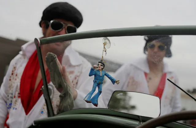 An Elvis Presley figurine hangs in a convertible as as participants in street parade honouring Elvis Presley prepare the car at the 25th annual Parkes Elvis Festival in the rural Australian town of Parkes, west of Sydney, January 14, 2017. (Photo by Jason Reed/Reuters)
