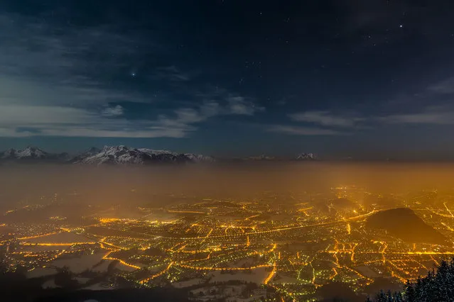 In this view of Salzburg, Austria, a blanket of cold fog filters out light from the city, allowing the stars above the surrounding mountain range to sparkle. And despite the glow of a near full moon, the wintertime constellations of Orion and Taurus, as well as the planet Jupiter, burn brightly. The photo, taken by Andreas Max Böckle, was a winner in the Fourth International Earth and Sky Photo Contest. It was published – along with a gallery of other winning shots – by National Geographic Daily News in May. (Photo by Andreas Max Böckle/National Geographic)