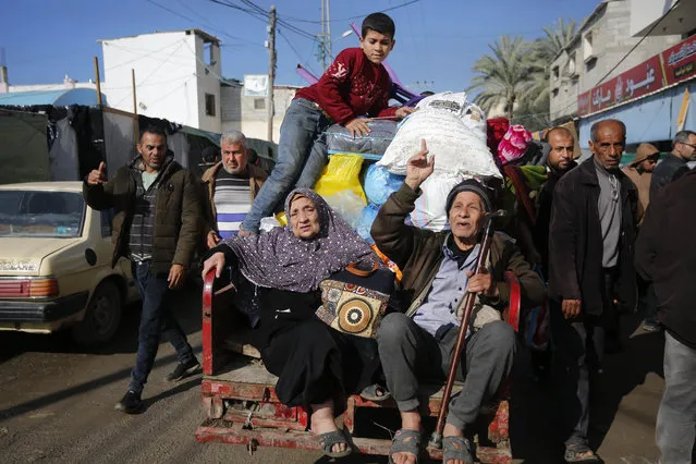 Palestinian citizens carrying their belongings leave their homes in Al-Maghazi refugee camp to seek safer places in the city as Israeli attacks continue in Deir al-Balah, Gaza on January 04, 2024. (Photo by Ashraf Amra/Anadolu Agency)