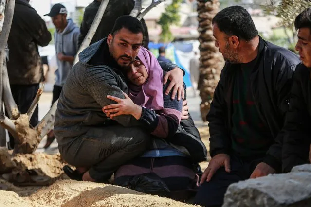 Relatives and loved ones of the Palestinians, who got killed during Israeli attacks, mourn as they bury the bodies in the yard of Nasser Hospital since they cannot reach the cemeteries due to attacks in Khan Yunis, Gaza on January 19, 2024. (Photo by Jehad Alshrafi/Anadolu via Getty Images)
