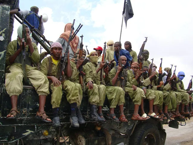 In this October 30, 2009 file photo, al-Shabab fighters sit on a truck as they patrol in Mogadishu, Somalia. Somalia's intelligence service cooperated with the U.S. in airstrikes that killed more than 150 al-Shabab members on Saturday, an intelligence official said Tuesday, March 8, 2016. The airstrikes targeted a forested military training camp run by the Islamic extremists 200 kilometers (124 miles) north of the capital Mogadishu, the official said, adding that the camp was al-Shabab's main planning base. (Photo by Mohamed Sheikh Nor/AP Photo)