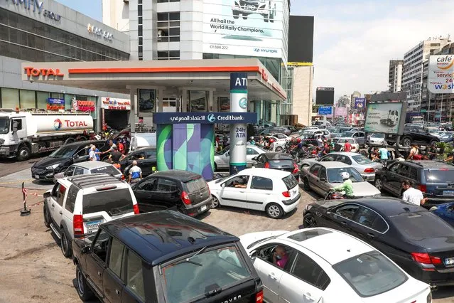 People wait in cars to get fuel at a gas station in Zalka, Lebanon, August 20, 2021. Roads have been clogged as motorists have queued for the little gasoline left. Prices have soared on the black market. Some confrontations over gasoline have turned deadly. The fuel oil that powers much of Lebanon has also nearly run out, leading to lengthy blackouts. (Photo by Mohamed Azakir/Reuters)