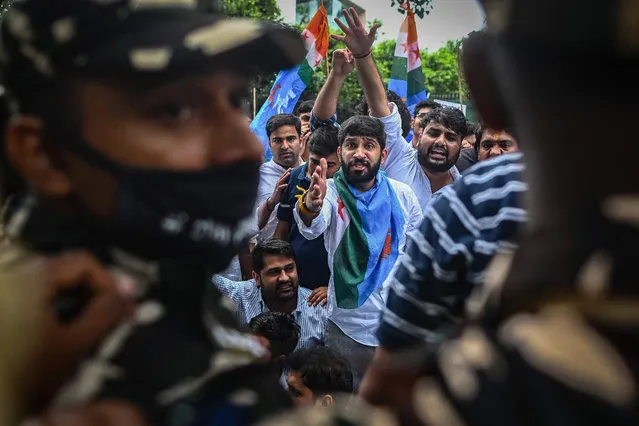 Student activists from National Students' Union of India (NSUI) shout slogans during a demonstration in New Delhi on October 18, 2021 against fresh outbreak of violence in Indian-administered Kashmir in which two labourers were killed by gunmen. (Photo by Sajjad Hussain/AFP Photo)