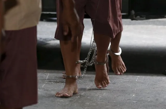 The shackled legs of suspected human traffickers are seen as they arrive for their trial at the criminal court in Bangkok, Thailand, March 15, 2016. (Photo by Chaiwat Subprasom/Reuters)