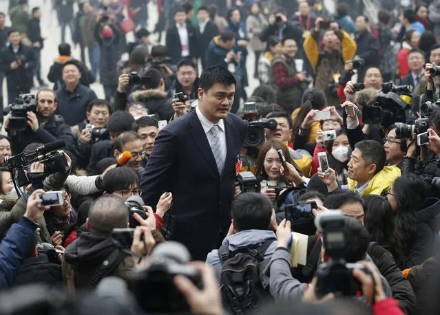 Former NBA basketball player Yao Ming, who is a delegate of the Chinese People's Political Consultative Conference, is surrounded by media ahead of the opening of CPPCC outside the Great Hall of the People in Beijing on March 3, 2014. (Photo by Kim Kyung-Hoon/Reuters)