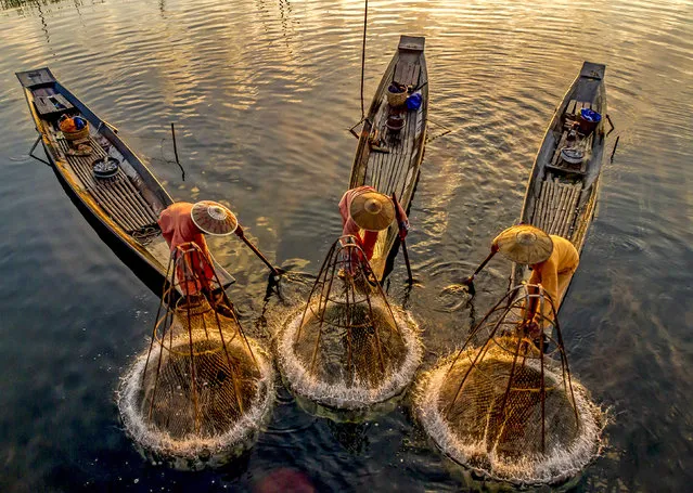 Fishermen make a splash as they throw conical nets into water at sunrise on the Inle Lake in Myanmar early January 2024. (Photo by Riza Amrullah/Solent News)