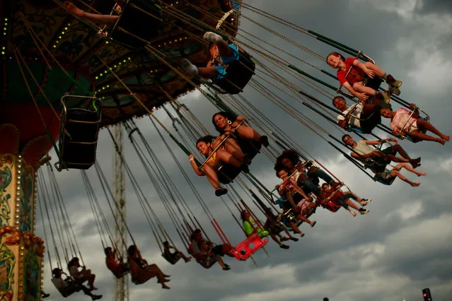 People enjoy a ride at an amusement park during Memorial Day weekend on May 26, 2019 in Seaside Heights, New Jersey. Memorial Day is the unofficial start of summer and this year New Jersey has banned smoking and vaping on nearly every public beach under tougher new restrictions. (Photo by Kena Betancur/Getty Images)