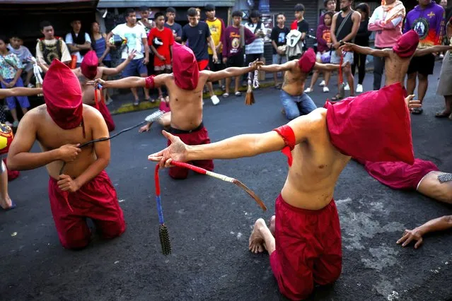 People watch as Filipino penitents perform self-flagellation on Maundy Thursday in Mandaluyong City, Metro Manila, Philippines, on March 28, 2024. (Photo by Eloisa Lopez/Reuters)